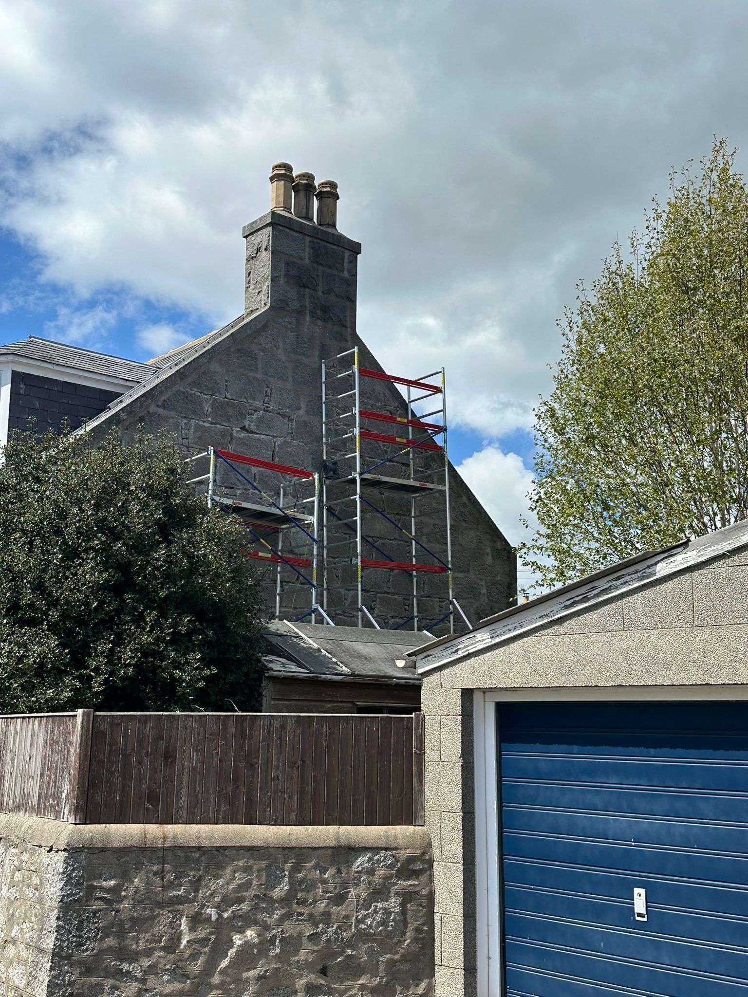 Scaffolding on gable end for chimney and stonework